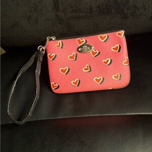 Coach pink wristlet with hearts.